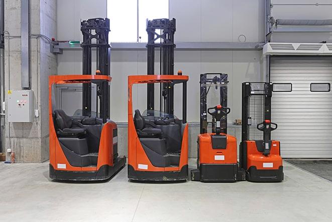 forklifts moving heavy machinery